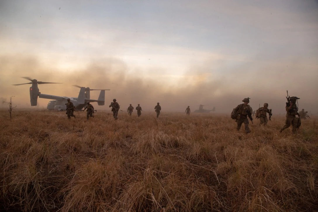 Marines in field leaving helicopter 
